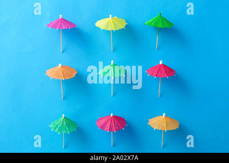 cocktail umbrellas on blue background Stock Photo
