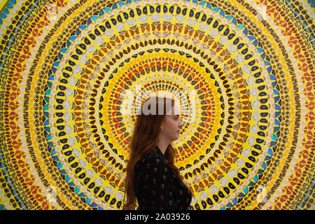 Gallery staff study one of Damien Hirst's pictures from his 'Mandalas' series, just prior to it opening at White Cube Mason's Yard gallery in London. The pictures are made from a collage of butterfly wings. Stock Photo