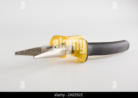 pliers with a long working part and dielectric handles are isolated on a white background Stock Photo