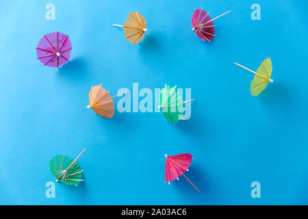 cocktail umbrellas on blue background Stock Photo