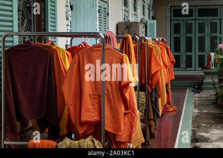 Bangkok, Thailand - 16 Aug 2019 : The vibrant orange robes worn by Chinese monks hung out to dry in the sun at Wat Bhoman Khunaram (Bhoman Khunaram Te Stock Photo