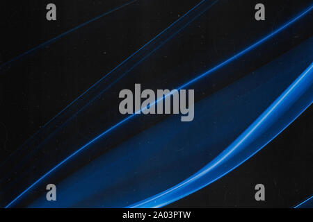 A real wisp of blue smoke on a black background with grain, dust and scratches overlay that makes an abstract artistic retro background Stock Photo