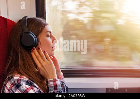 Young woman in headphones enjoying calm music in headphones Stock Photo