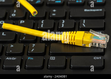 Internet connection disconnected, yellow network cable cutted off Stock Photo