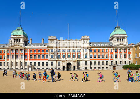 London, England UK. Horse Guards Parade and the Old Admiralty Building. Group of visiting primary school children Stock Photo