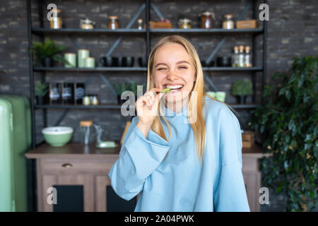 Beautiful young girl posing in the kitchen Stock Photo