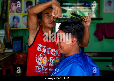 A Burmese Man Having A Haircut, Nyaung Shwe, Shan State, Myanmar Stock Photo