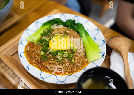 Taichung, Taiwan: A bowl of japanese Ramen Soup with sliced pork and a soft boiled egg on wooden table. Stock Photo