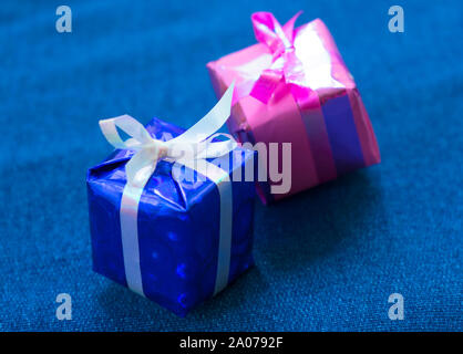 Two small gift decorative boxes on a blue background. Stock Photo
