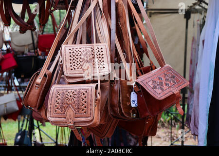 Leather handbags on a market stall in Menorca Stock Photo