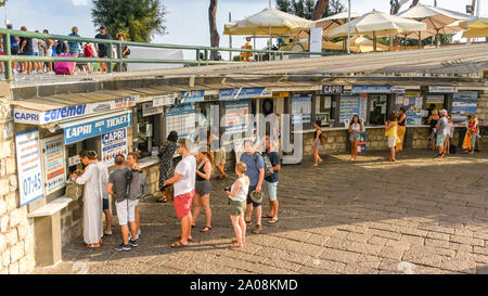 SORRENTO, ITALY - AUGUST 2019: People queuing to buy ferry tickets in the port of  Sorrento Stock Photo