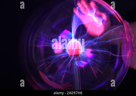 Closeup of plasma ball / globe and hands touching it Stock Photo