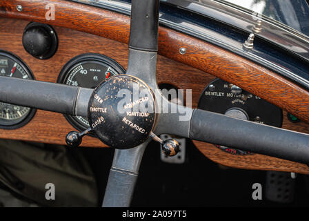 Dashboard and steering wheel of vintage Bentley car showing throttle and ignition controls Stock Photo