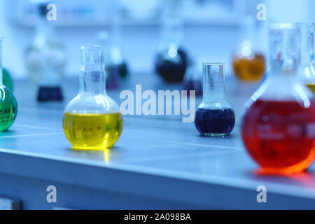 Laboratory glassware with colorful liquids on lab table. Science and education concept Stock Photo