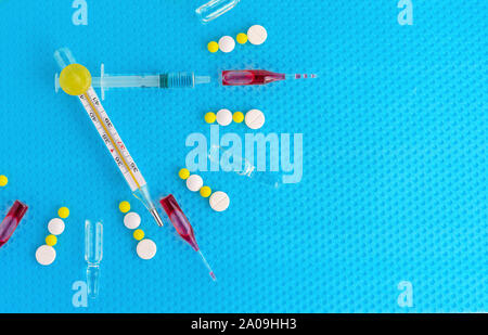 Medical watch made of ampoules, pills, thermometer and syringe. The concept of time taking medication. Stock Photo