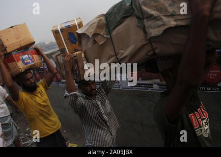 Dhaka, Bangladesh. 20th Sep, 2019. Workers deliver goods on their head near Wiseghat, countries biggest wholesale market in the bank of the Buriganga River. Credit: MD Mehedi Hasan/ZUMA Wire/Alamy Live News Stock Photo