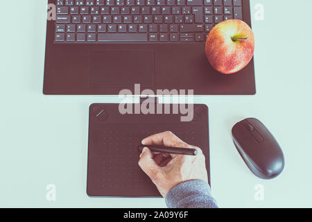 tablet drawing in workspace with laptop top view Stock Photo