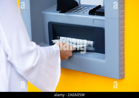 Close-up Of A Woman's Hand Holding Cash Withdraw From Automatic Teller Machine Stock Photo