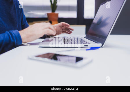 Anonymous man typing on laptop at office. Stock Photo
