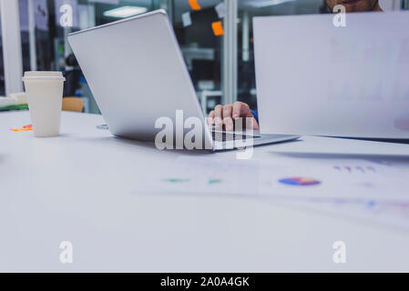 Anonymous man typing on laptop at office. Stock Photo
