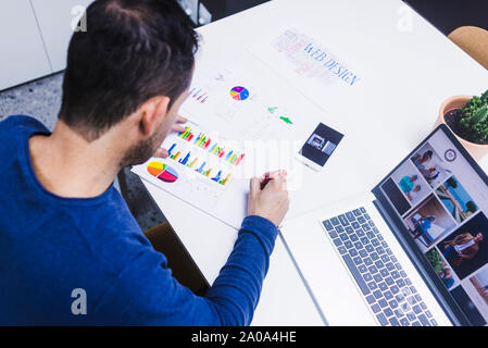 Man working on documents at desk in office Stock Photo