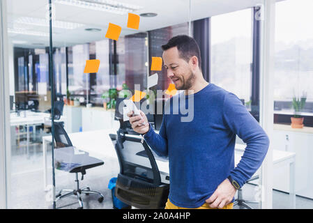 businessman using mobile phone in office Stock Photo