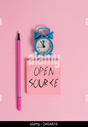 Text sign showing Open Source. Business photo text denoting software which original source code freely available Metal vintage alarm clock wakeup blan Stock Photo