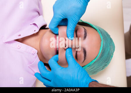 An Overhead View Physiotherapist Performing Jaw Massage Stock Photo