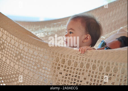 Baby and mom in hammock lay on vacation