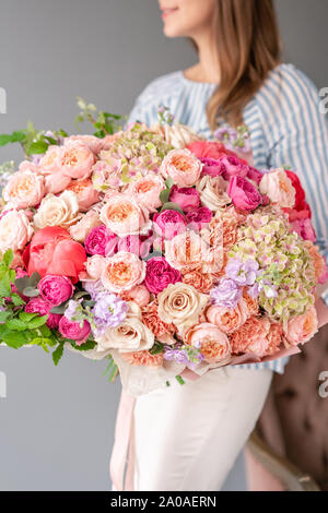 Large Beautiful bouquet of mixed flowers in woman hand. Floral shop concept . Beautiful fresh cut bouquet. Flowers delivery Stock Photo