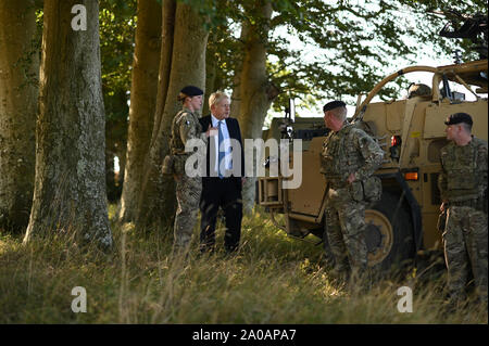 Prime Minister Boris Johnson meets with military personnel on Salisbury Plain training area near Salisbury. Stock Photo