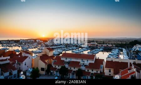 High perspective view of sunset at Vilamoura Marina, Algarve, Portugal with busy nightlife around the Marina full of shops and restaurants. Stock Photo