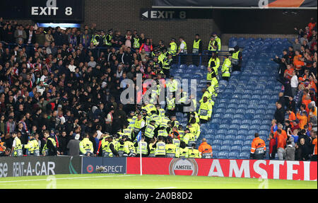 Fans clash with police in the stands during the UEFA Europa League Group G match at Ibrox Stadium, Glasgow. Stock Photo