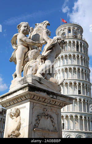 Cupid Statue and Leaning Tower of Pisa, Piazza dei Miracoli, Pisa, Italy Stock Photo