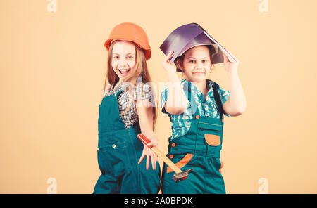 Family remodeling house. Control renovation process. Kids happy renovating home. Home improvement activity. Kids girls with tools planning renovation. Children sisters renovation their room. Stock Photo
