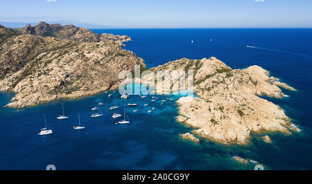 View from above, stunning aerial view of Cala Coticcio also known as Tahiti with boats and yachts floating on a turquoise clear water. Stock Photo
