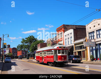 MEMPHIS, TENNESSEE - JULY 23, 2019: An electric streetcar trolley cruises along under it's power lines on Main St. in Memphis, Tennessee on a summer d Stock Photo