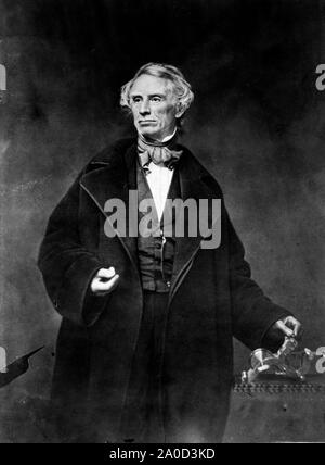 Samuel F.B. Morse, half-length portrait, posing with left hand on a telegraph apparatus, facing slightly left. In addition to being the inventor of  Morse Code, Morse was a highly skilled portrait painter, Stock Photo