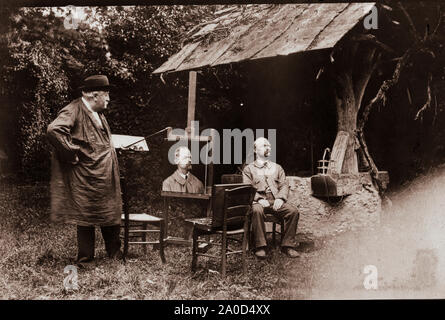 The painter Antoine Lumière painting portrait of posing man Stock Photo
