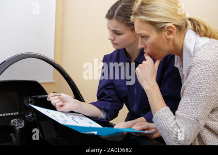 apprentice car mechanics working on an engine Stock Photo