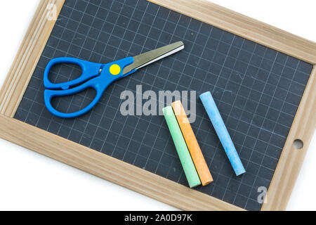 Closeup on colored chalk placed on a school slate Stock Photo