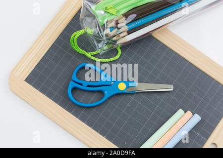 Closeup on colored chalk placed on a school slate Stock Photo