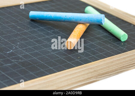 Closeup on colored chalk placed on a school slate Stock Photo