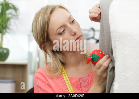 tailor woman working with mannequin in her workshop Stock Photo