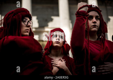Madrid, Spain. 19th Sep, 2019. Extinction Rebellion activists wearing red outfits gather in front of the Spanish Parliament during the protest.Extinction Rebellion activists perform in Madrid, ending in front of the Spanish Parliament, to protest against the repetition of elections and the consequent loss of time to take urgent measures to avoid climate change. Credit: SOPA Images Limited/Alamy Live News Stock Photo