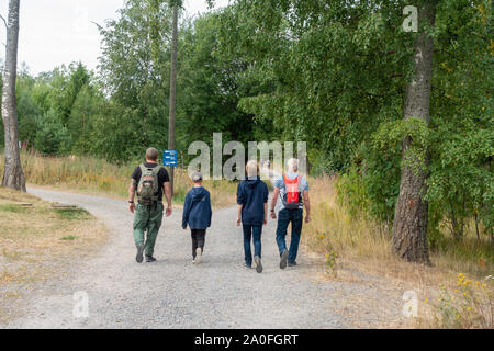 Group of men walking on the Isosaari island in Helsinki Finland Stock Photo