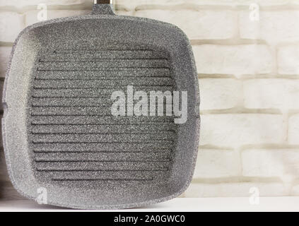 empty grill pan with non-stick coating on light background Stock Photo
