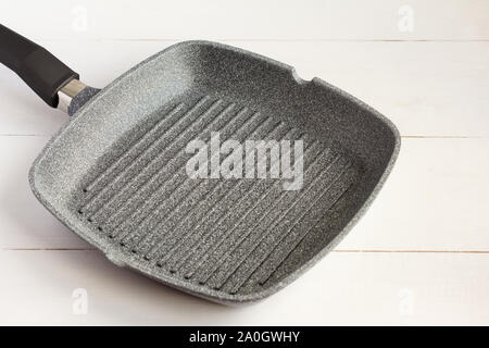empty grill pan with non-stick coating on light background Stock Photo
