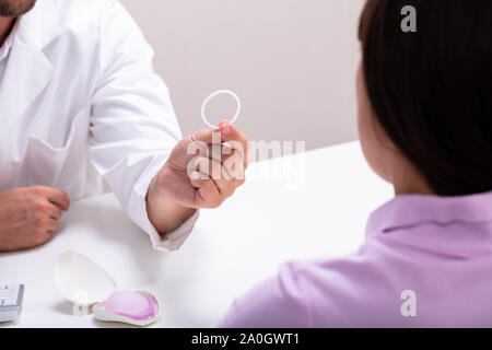 Gynecologist Showing Contraception Ring To Woman And Explaining Contraception And Birth Control Methods Stock Photo