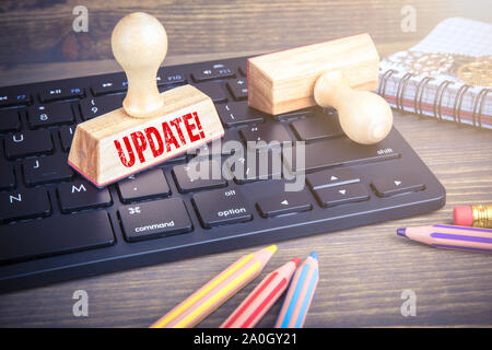 Update concept. Wooden stamp on computer keyboard Stock Photo